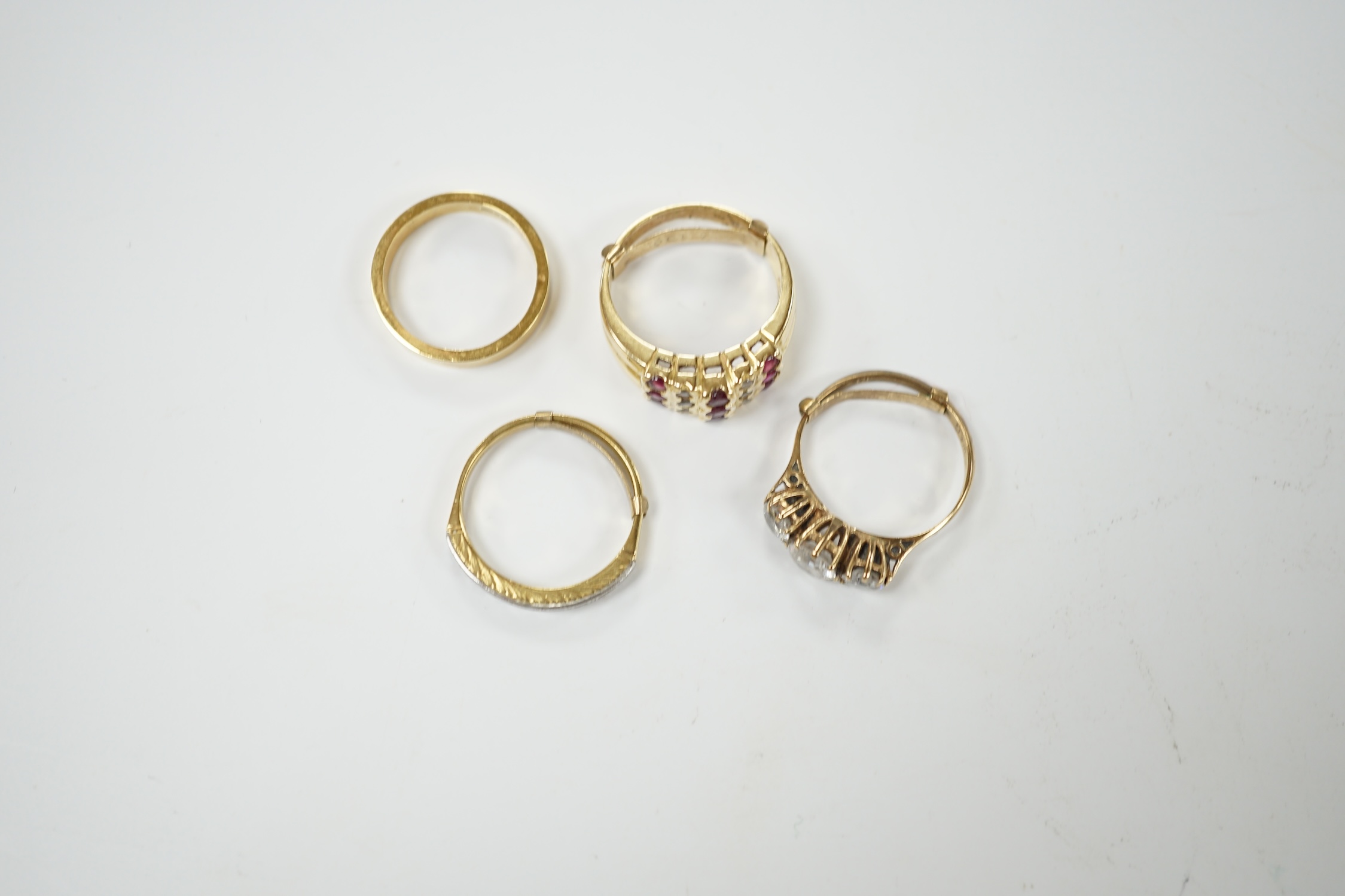 An 18ct and diamond chip set half hoop ring, size L/M, an 18ct gold band and two 9ct and gem set rings. Condition - fair
